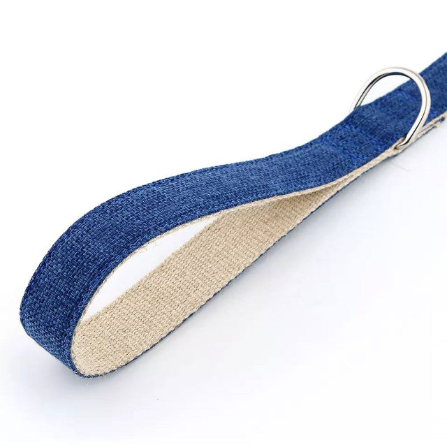 Close up of dog lead in ink blue. It details the webbing of the cotton and hemp blend as well as showing the quality metal D clip attachment. The image is on a white background