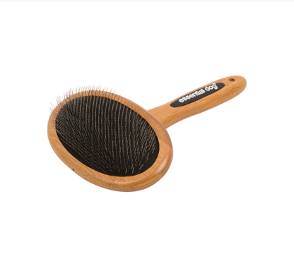Natural bamboo slicker brush with angled bristles close up on white background